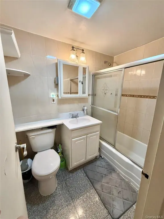 Full bathroom with tub and glass shower doors