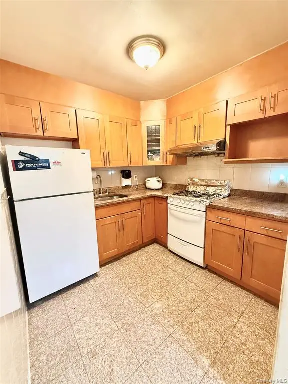 Kitchen with wood cabinetry and gas range