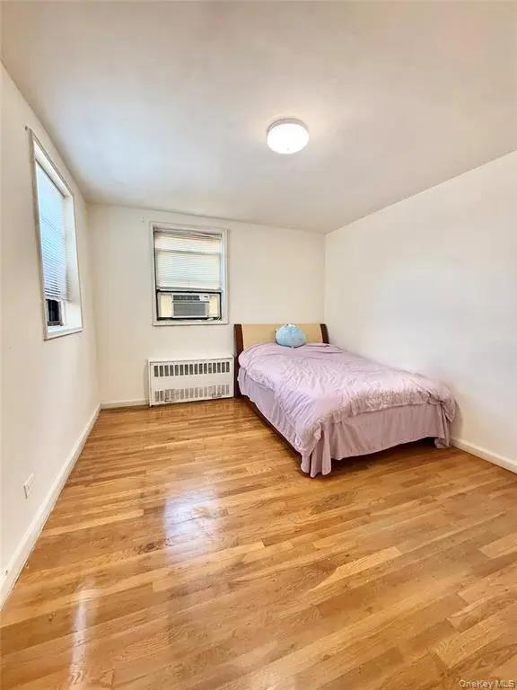 Bright bedroom with hardwood flooring