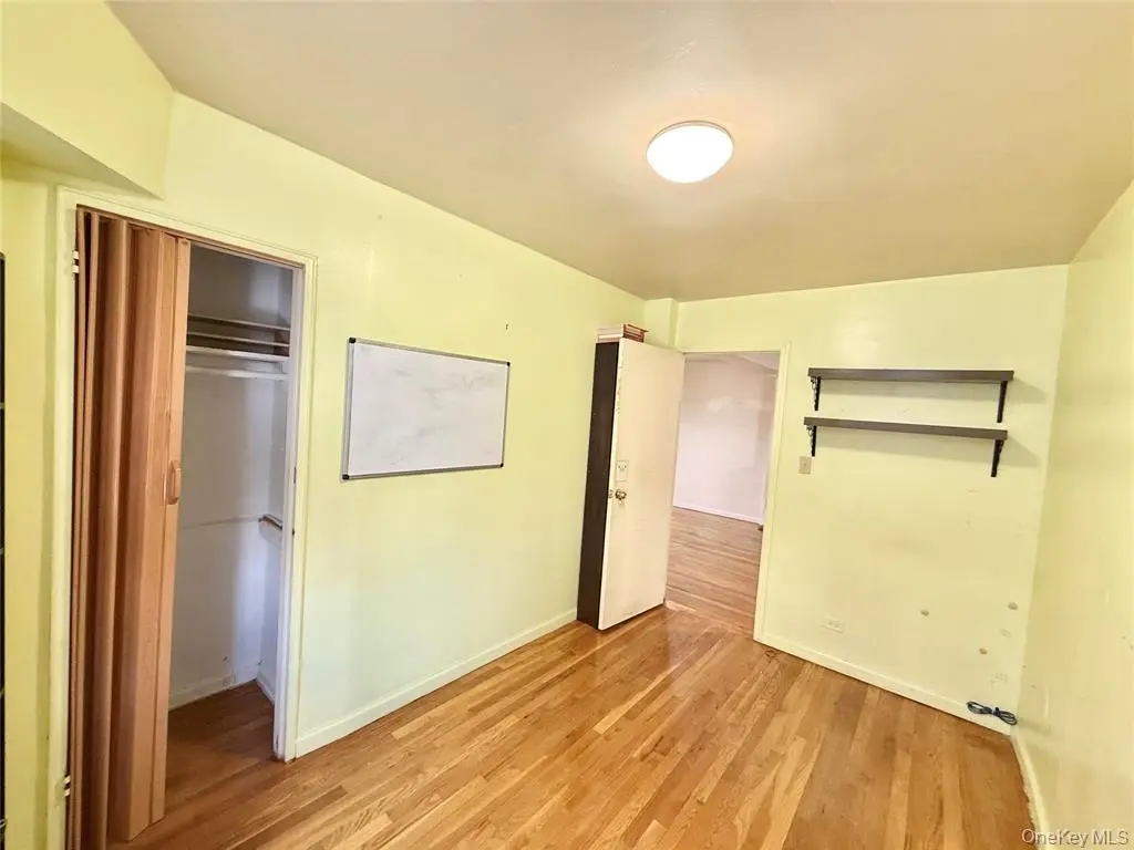 Bedroom view showing closets and wood floor