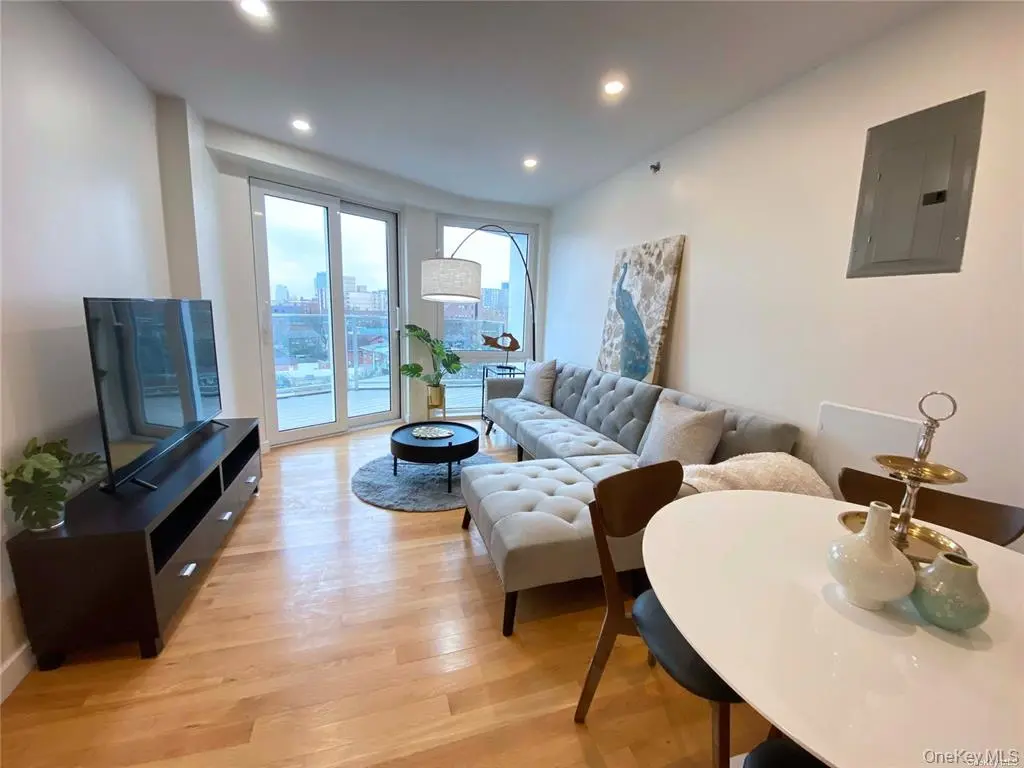 Bright open living and dining area with balcony doors