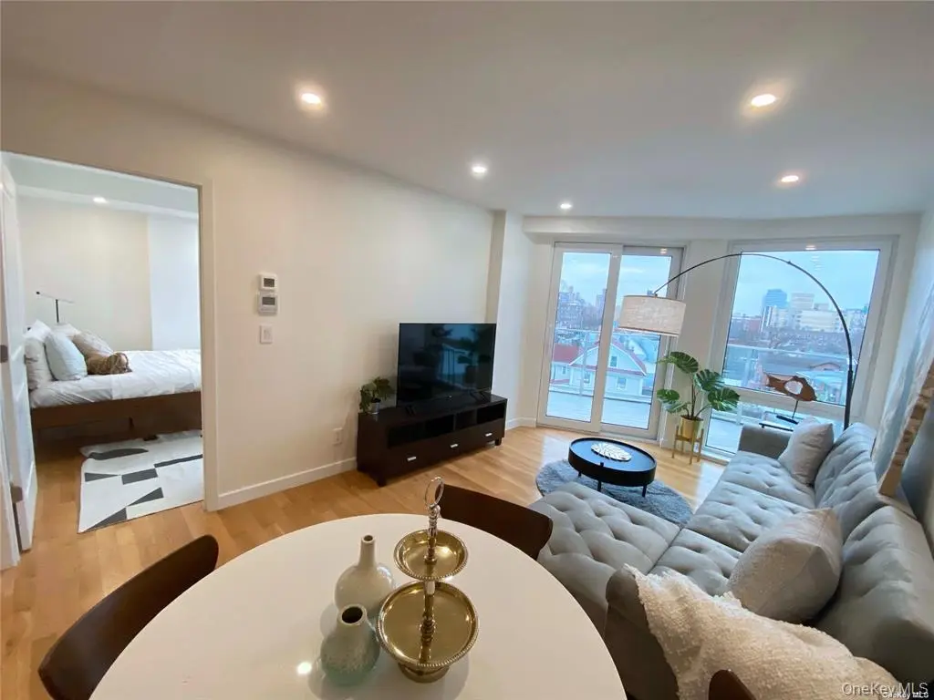 Open living area with bedroom doorway and large windows