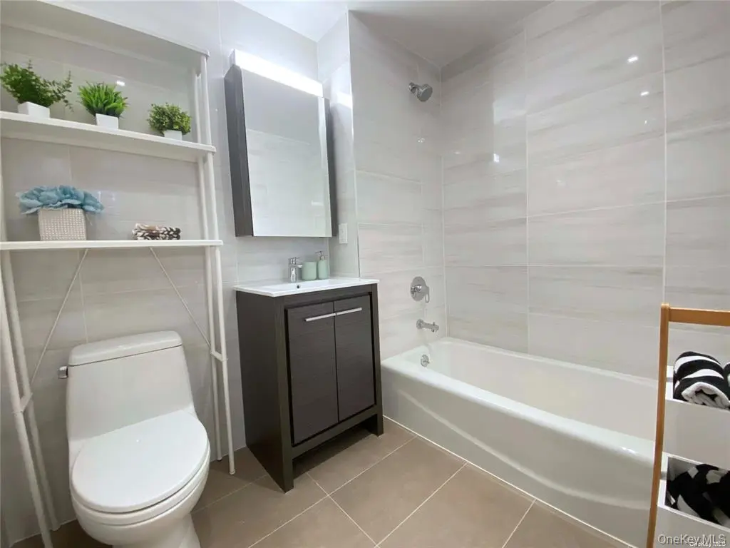 Second full bathroom with tub and vanity