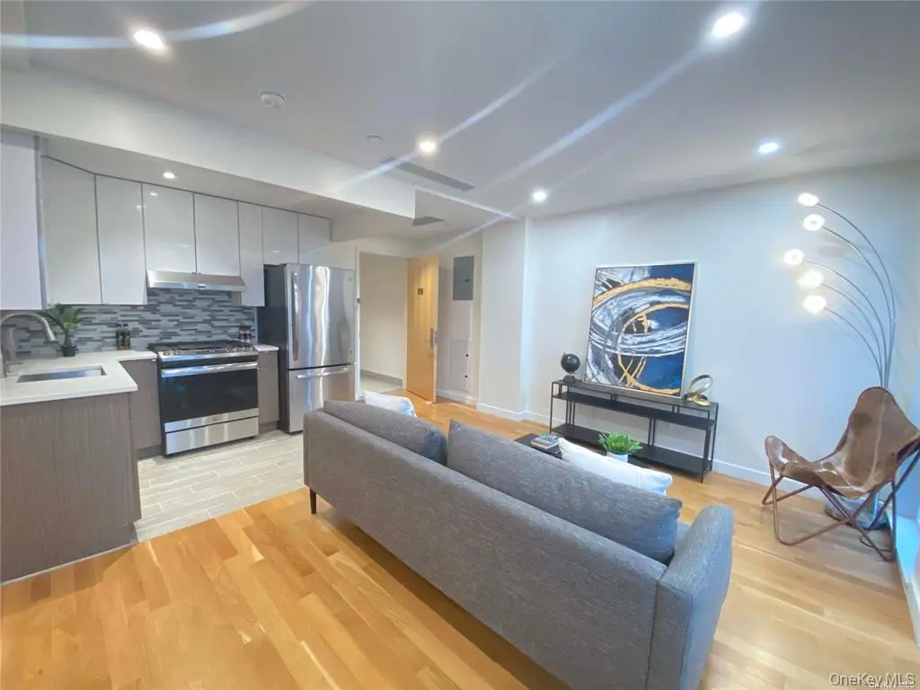 Kitchen and living area with hardwood floors