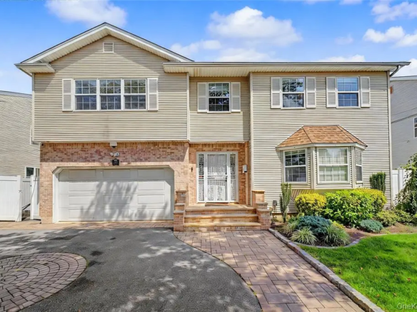 Front exterior with garage and driveway