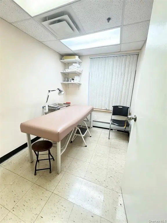 Treatment room with sink and bed