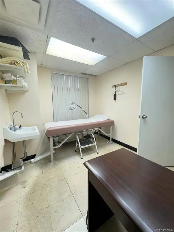 Treatment room with sink and examination bed