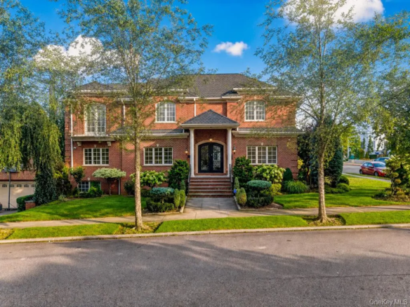Brick house front exterior with landscaped lawn