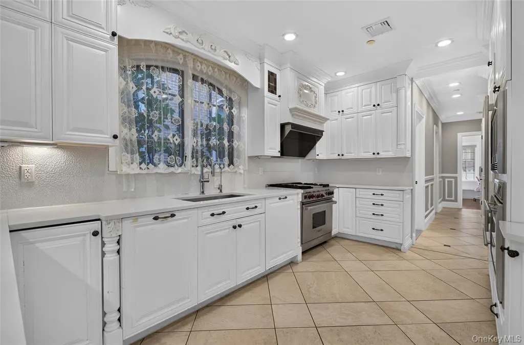 White kitchen cabinets and cooking area