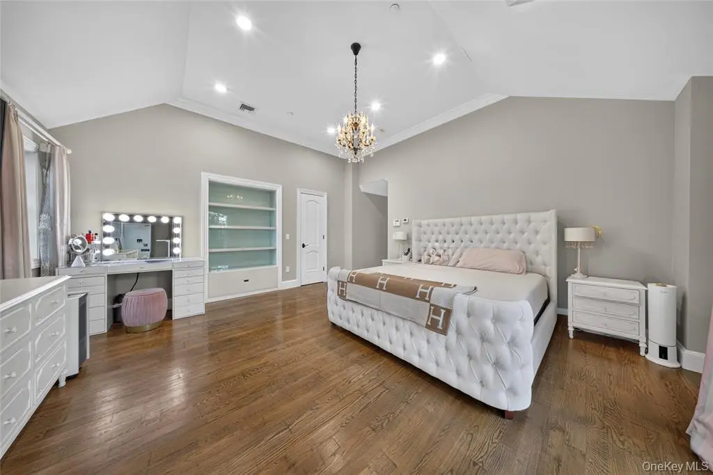 Bedroom with windows and chandelier