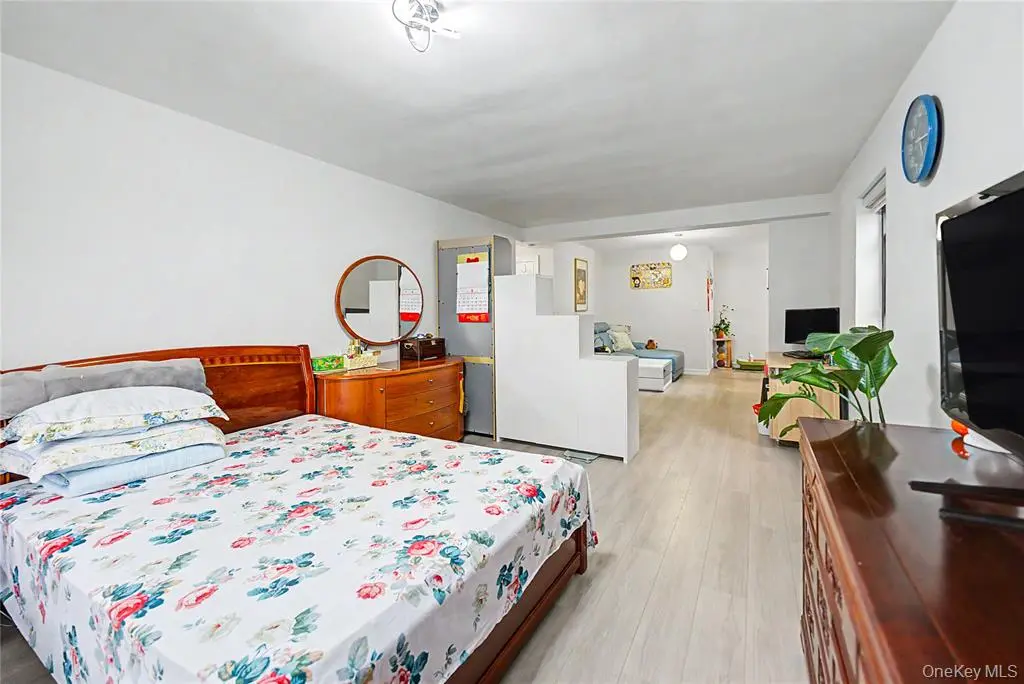 Bedroom with wood floor and storage