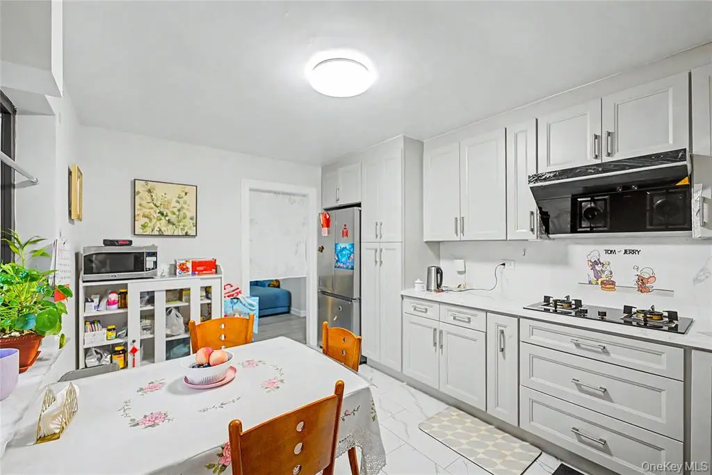 White kitchen with stainless steel appliances