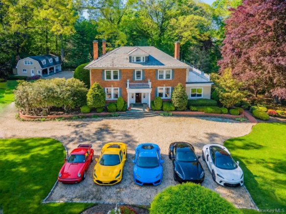 Aerial front view of the brick Colonial home and circular driveway in Glen Cove