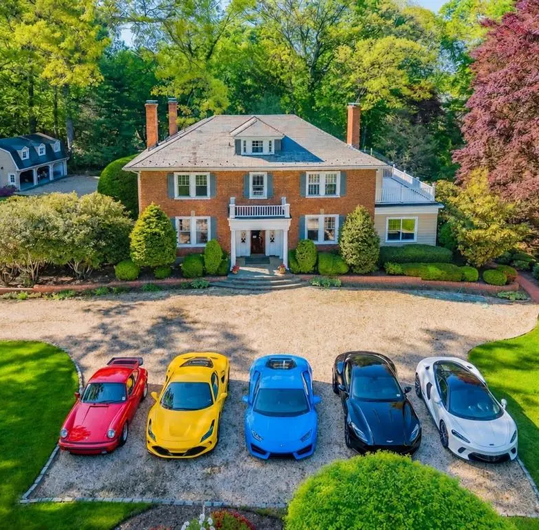 Aerial front view of the brick Colonial home and circular driveway in Glen Cove