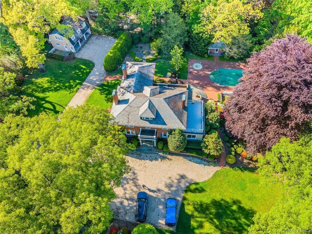 Aerial view of the Glen Cove estate, guest house, pool, and landscaped grounds