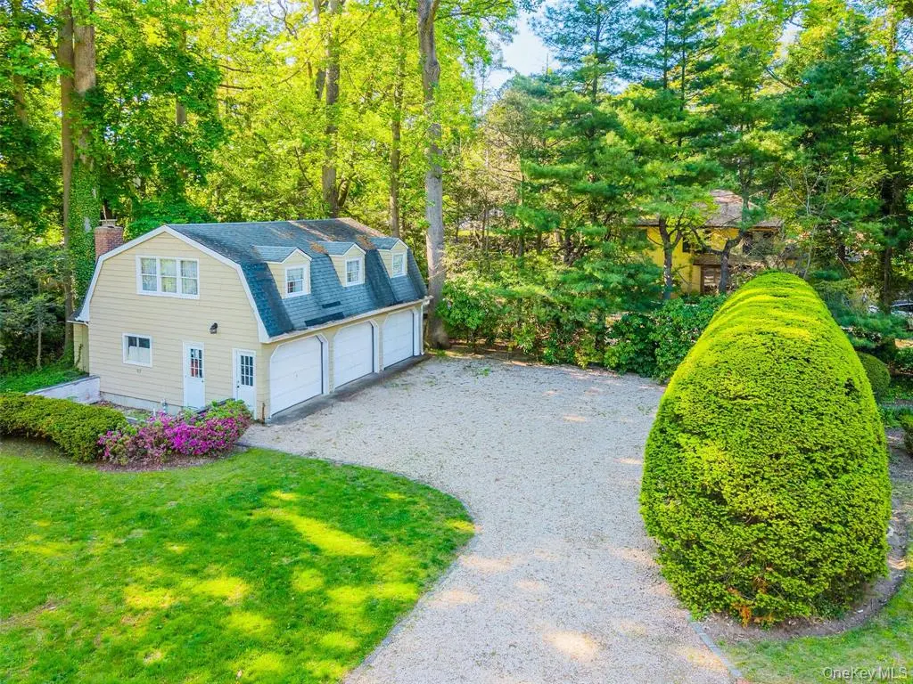 Detached guest house and three-car garage beside the driveway
