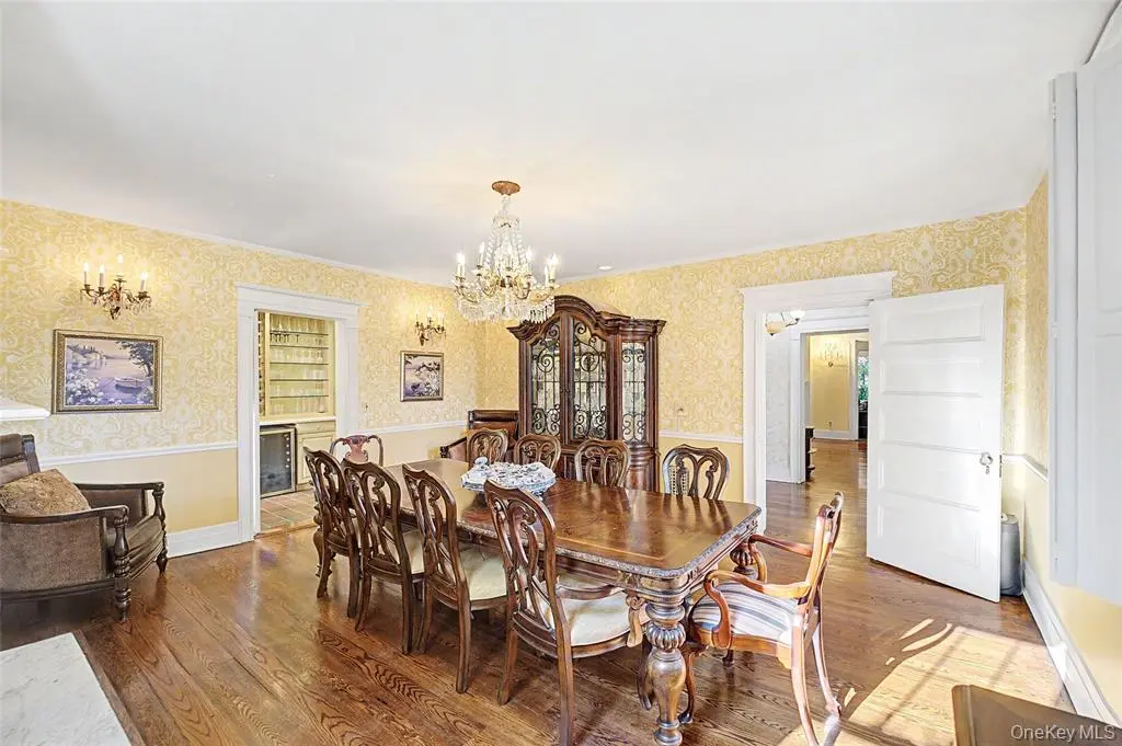 Formal dining room with hardwood floor and chandelier