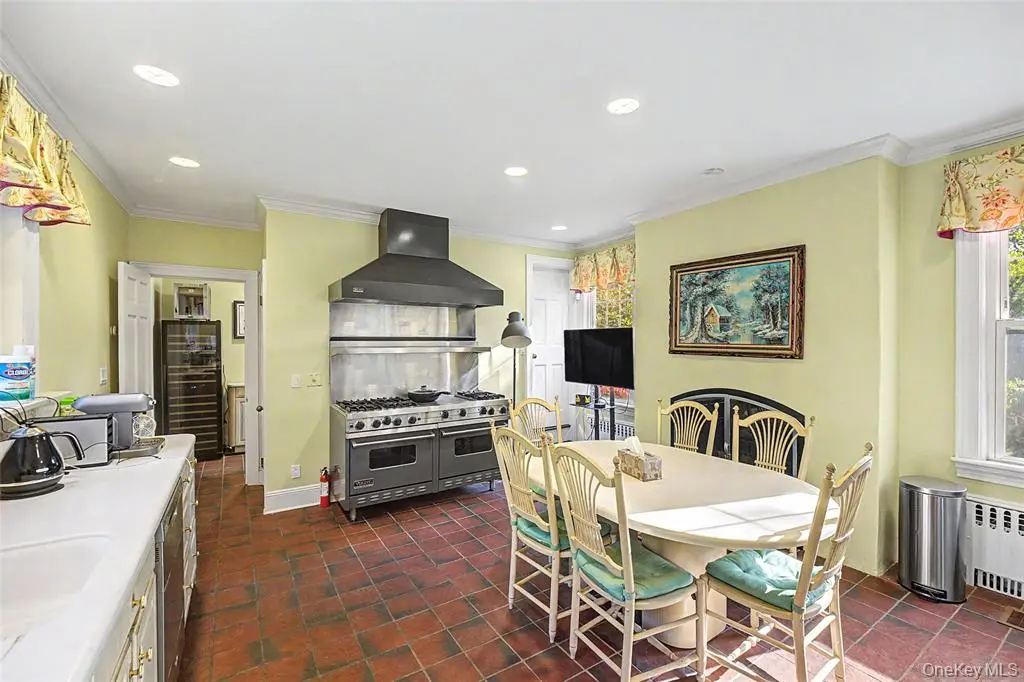Eat-in kitchen with brick floor and fireplace