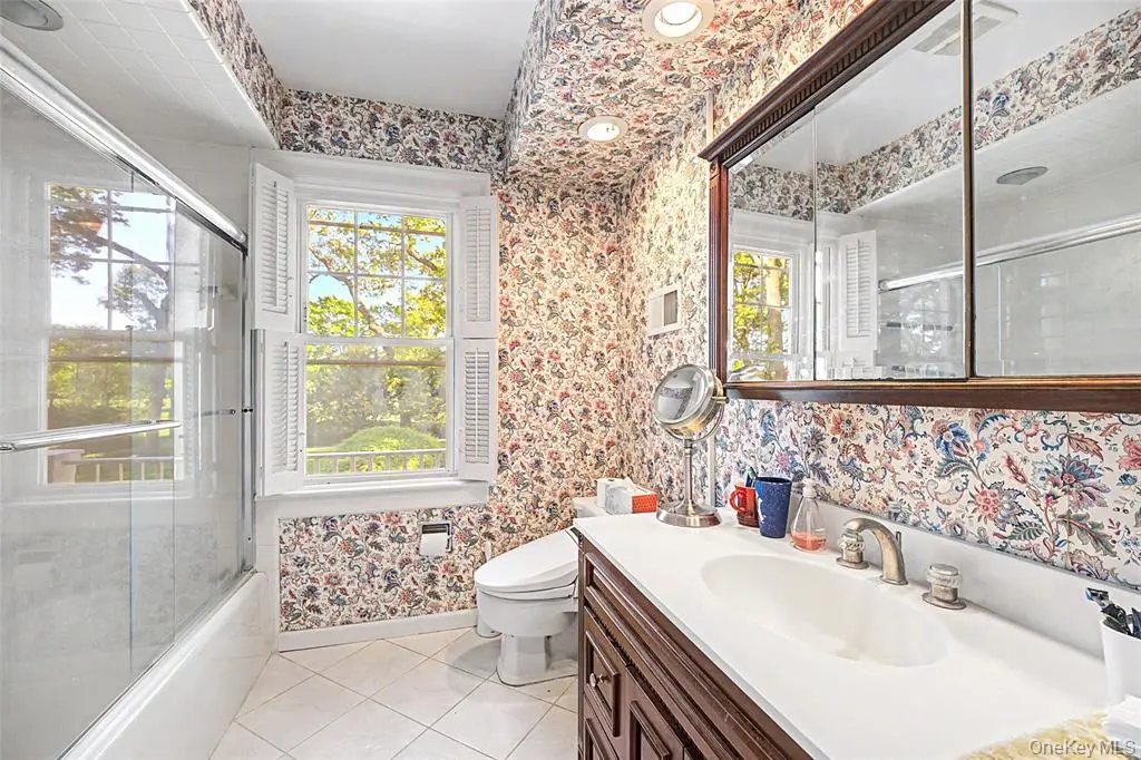 Full bathroom with double vanity and soaking tub