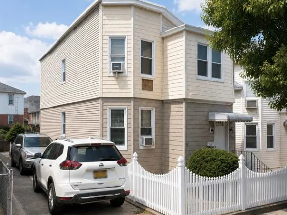 Two-family home exterior and private driveway in College Point