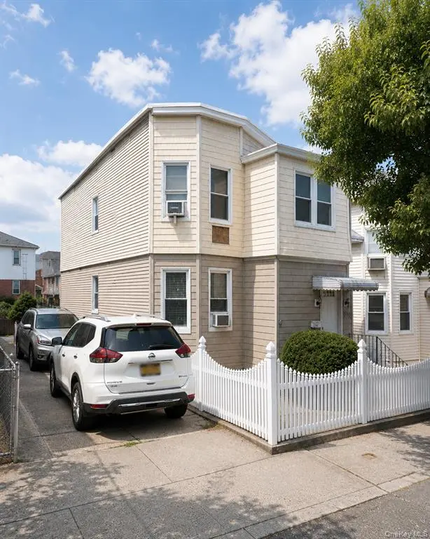 Two-family home exterior and private driveway in College Point