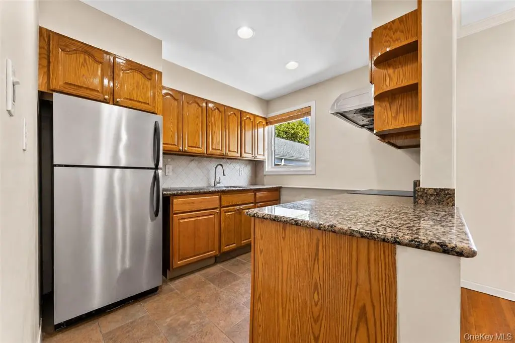 Wood cabinetry and stainless refrigerator