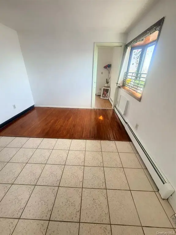 Bright dining and living area with hardwood flooring