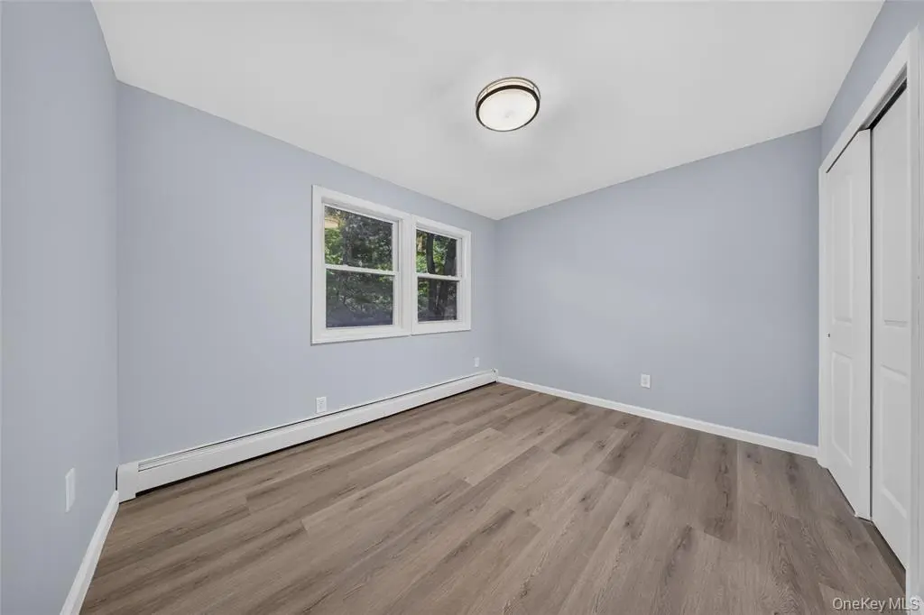Bedroom with hardwood-style flooring