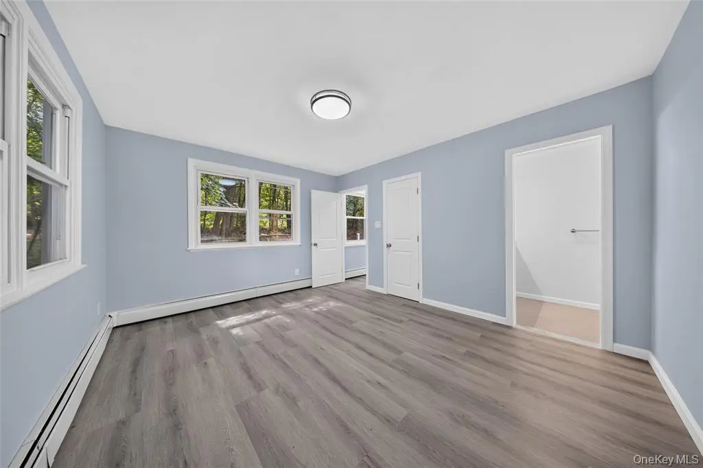 Primary bedroom with multiple windows