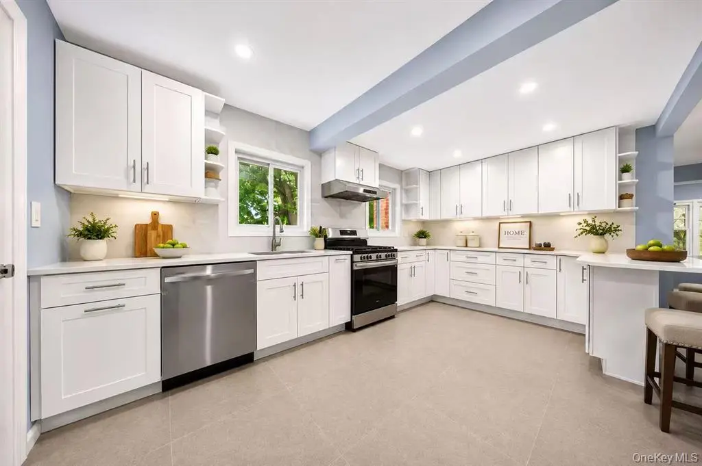 Renovated white kitchen with stainless steel appliances
