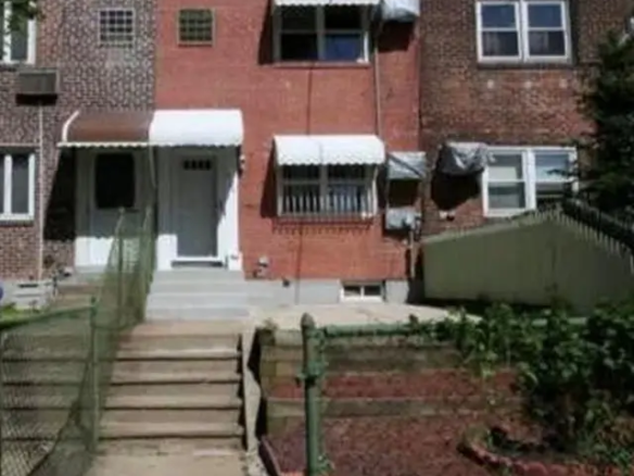 Brick two-family home exterior in College Point