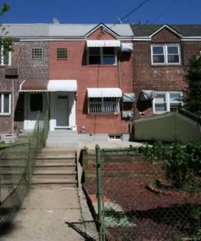 Brick two-family home exterior in College Point