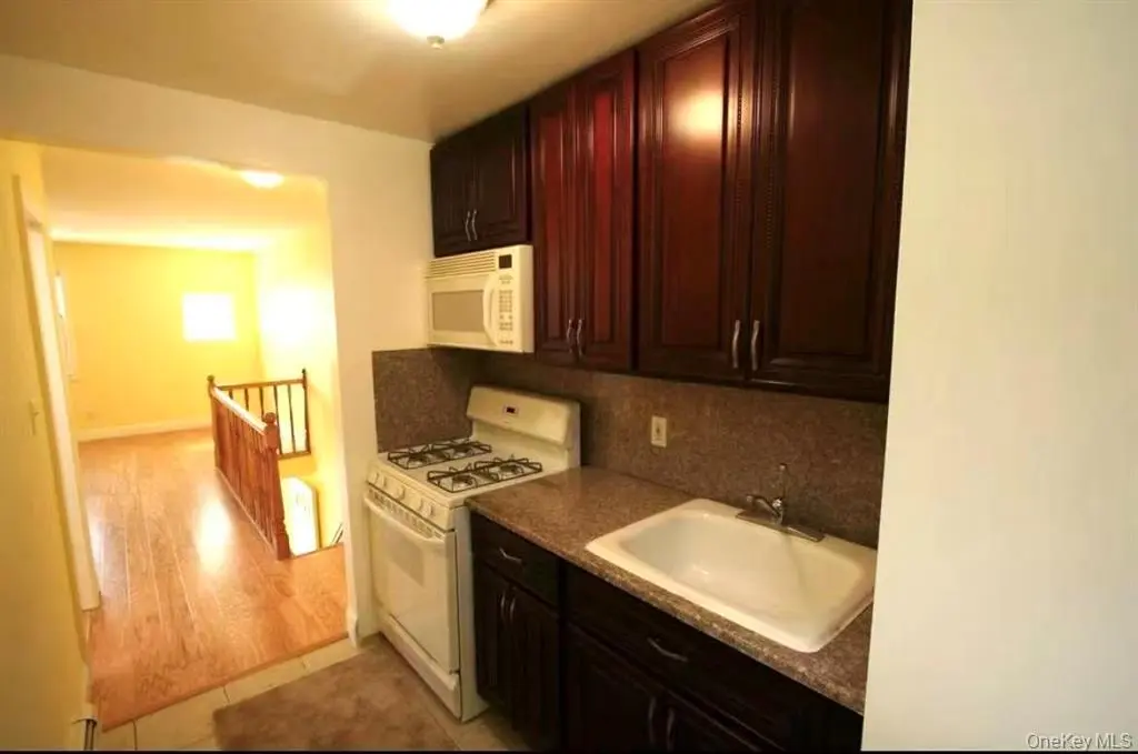 Second kitchen with dark wood cabinets