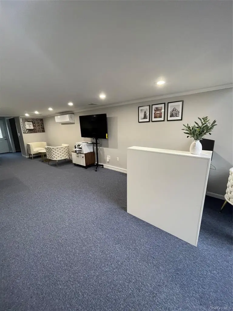 Open office reception area with seating and workstations