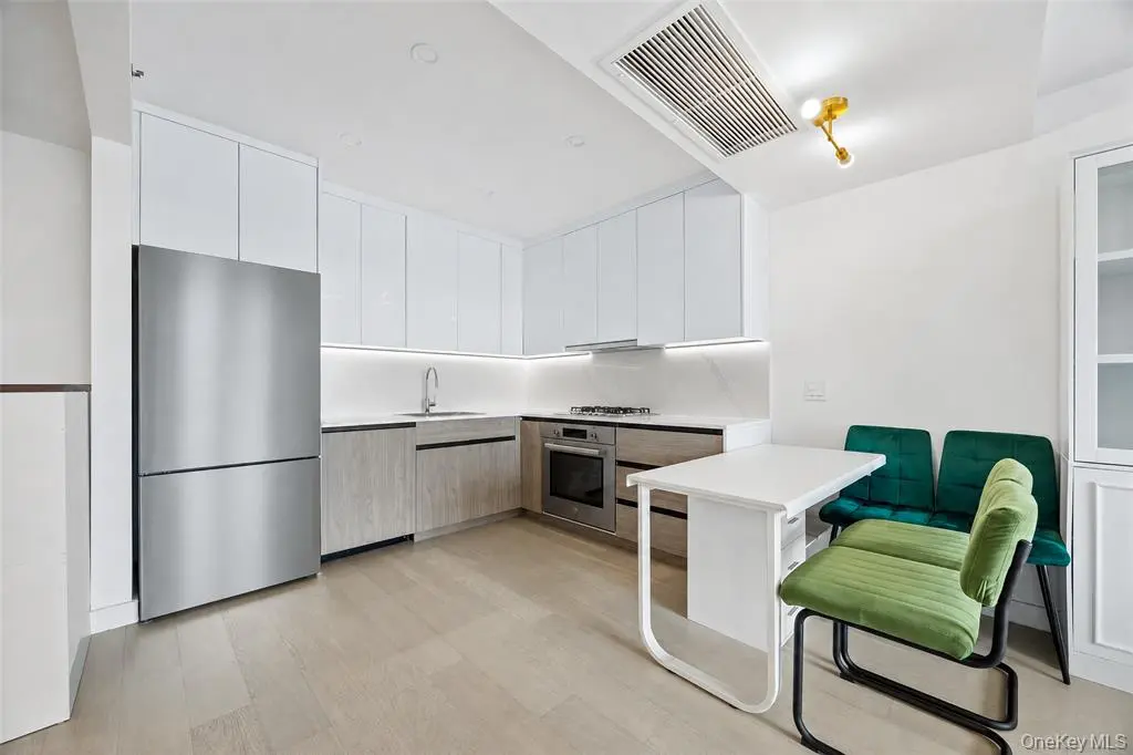 White open kitchen with stainless steel appliances