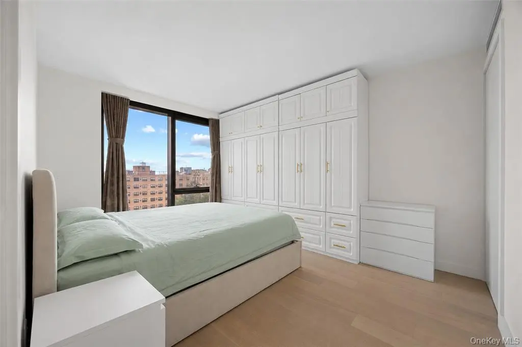 Bedroom with large window and built-in wardrobes