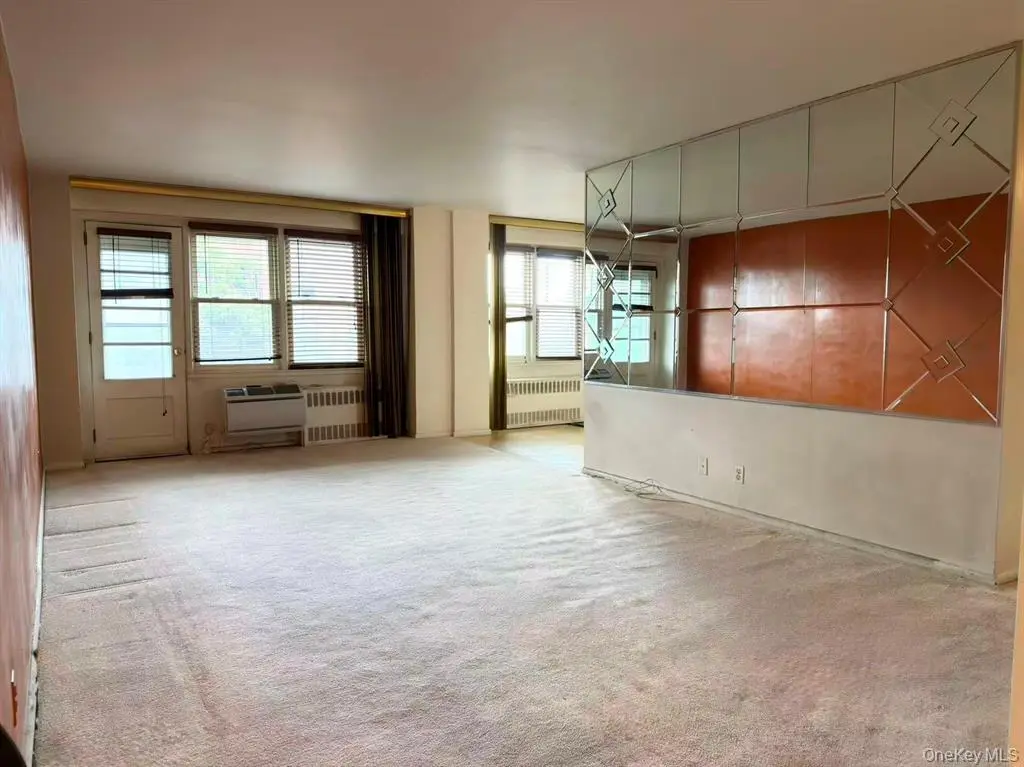 Spacious living room with balcony access at Carlyle Towers in Flushing