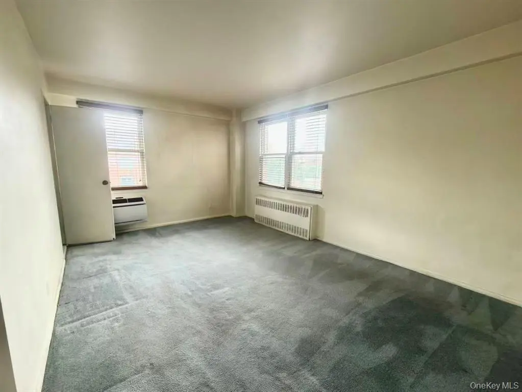 Corner bedroom with multiple windows and natural light