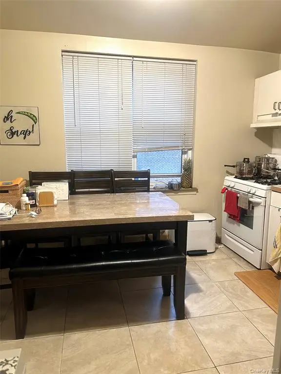 Windowed kitchen and dining area in the one-bedroom co-op