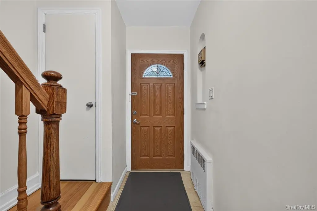 Renovated entry foyer with wood staircase