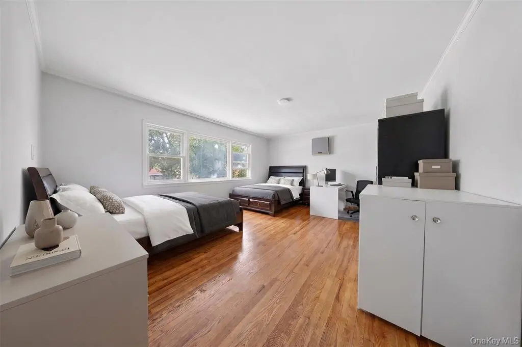 Spacious bedroom with hardwood flooring