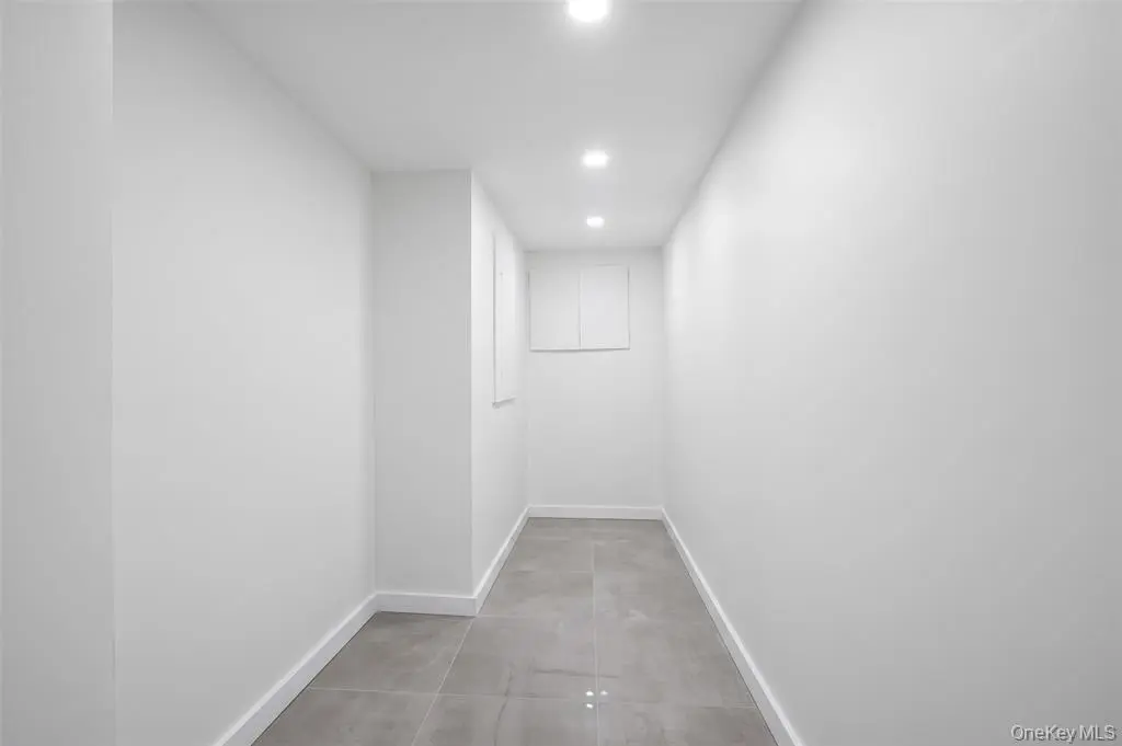 Finished basement room with recessed lighting