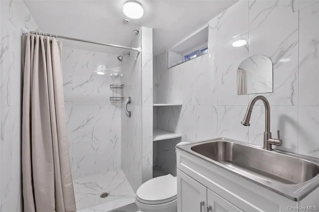 Lower-level bathroom with shower and vanity