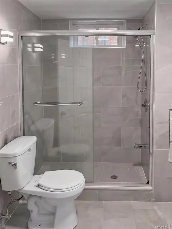 Glass-enclosed shower and bathroom fixtures