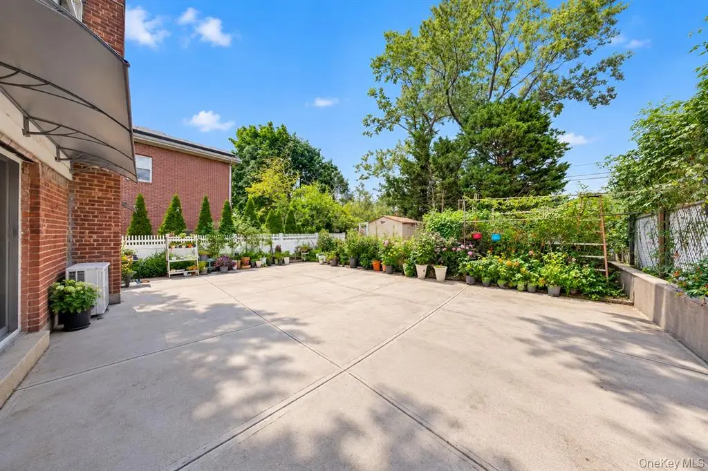 Wide paved driveway and rear patio area