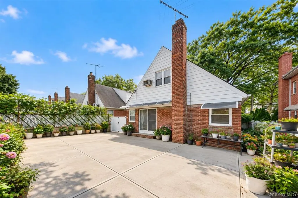 Rear view of the home and spacious paved yard