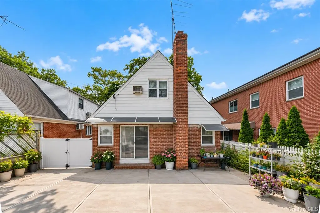 Rear exterior of the detached home with garden beds
