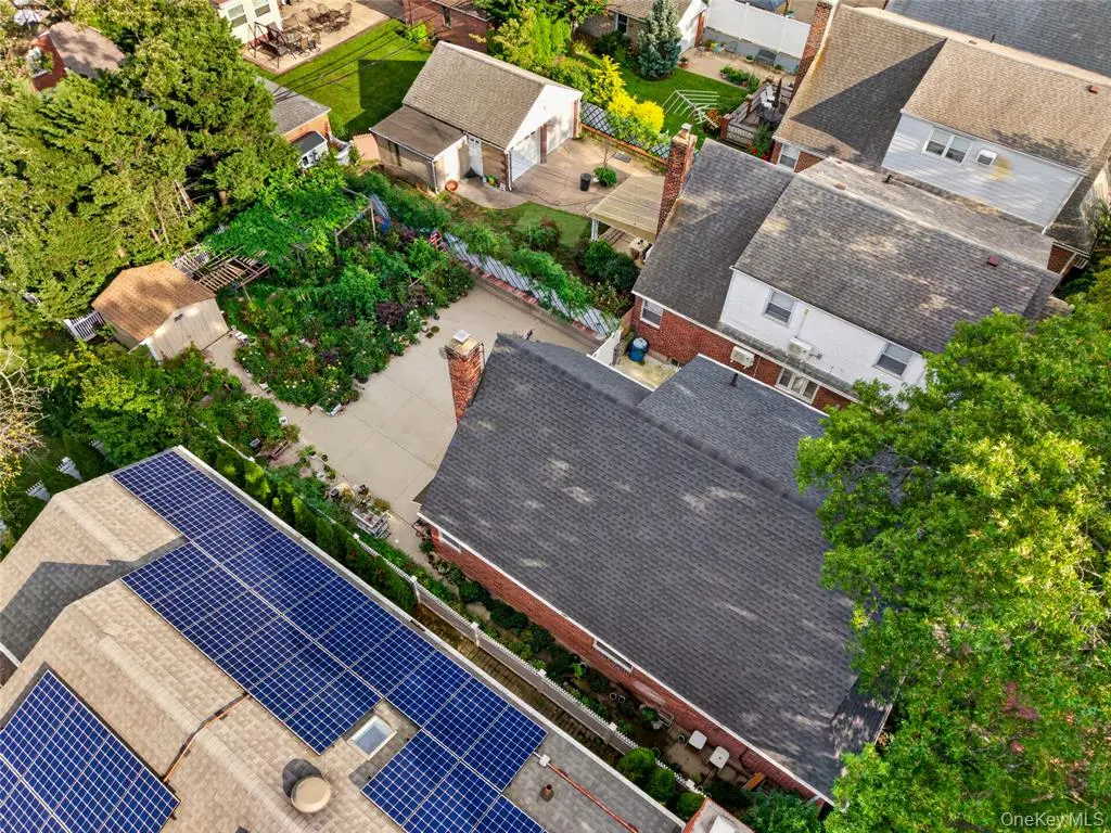 Oblique aerial view of the home and surrounding neighborhood