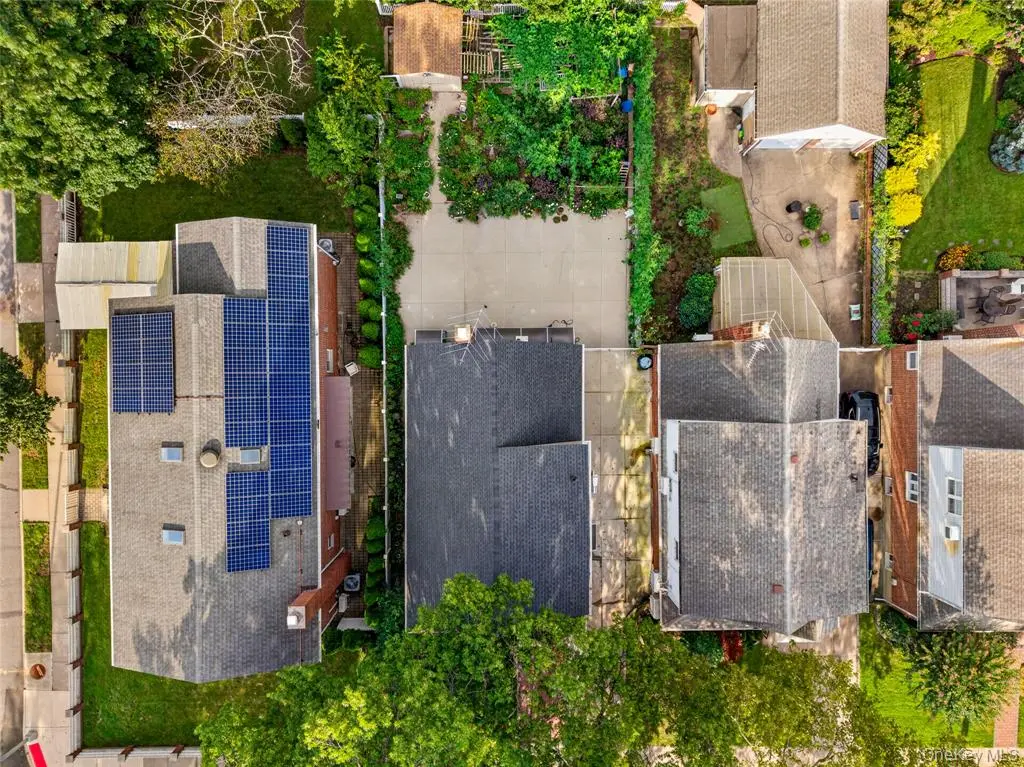Top-down aerial view of the house, driveway, and backyard