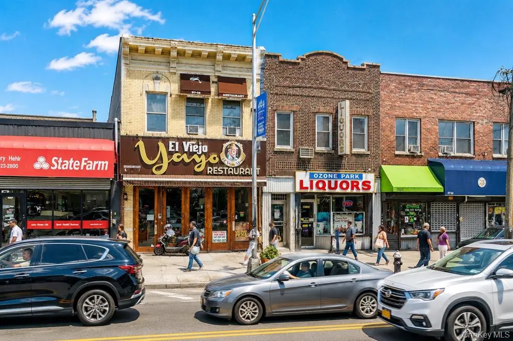 Street view of the Ozone Park mixed-use building and neighboring storefronts